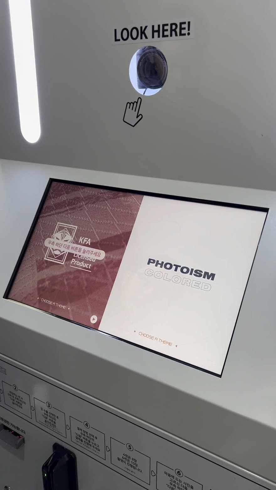 PHOTOISM COLORED 的機台橫式觸控螢幕，畫面上顯示 KFA 官方授權相框選項與 PHOTOISM 標示