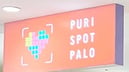 PURI SPOT PALO storefront sign on an orange-red background, with a pixel-style heart on the left and PURI SPOT PALO on the right